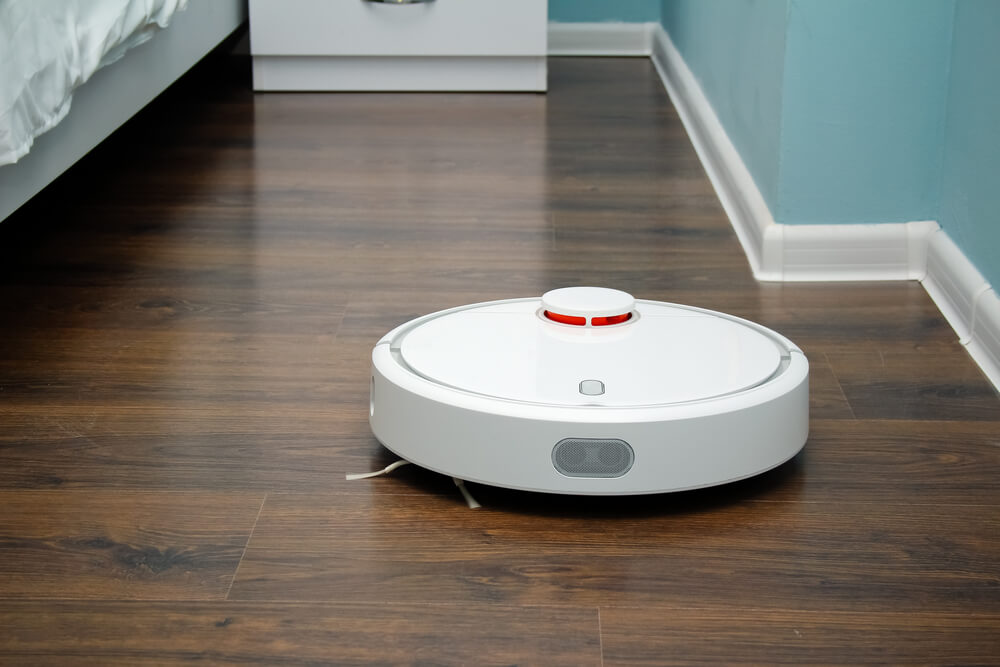 a robot vacuum cleaner slowly cleaning a certain area of the house