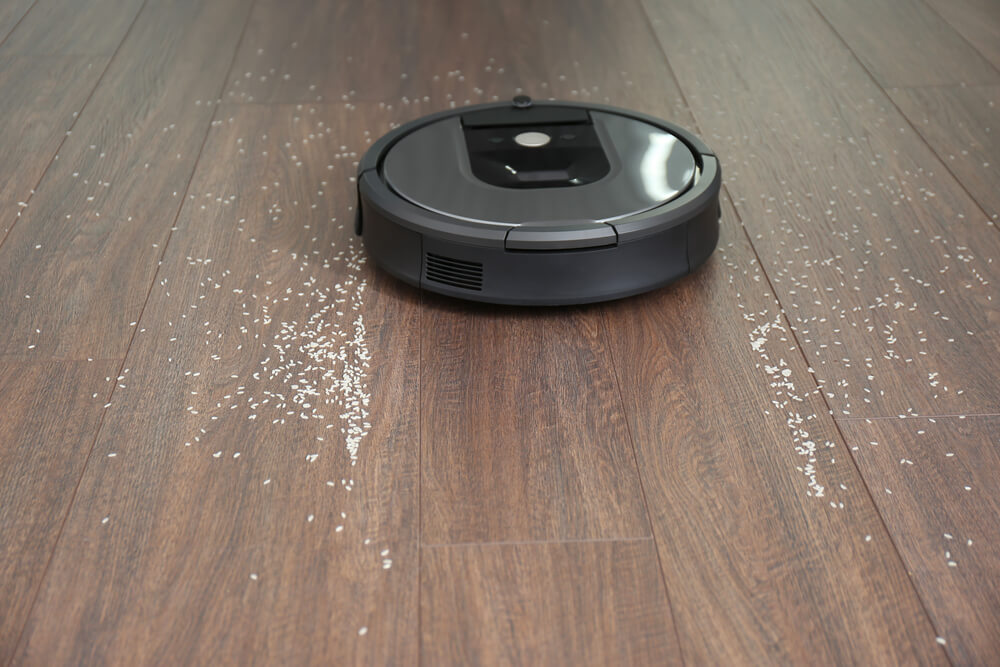 a Roomba robot vacuum cleaner cleaning the house