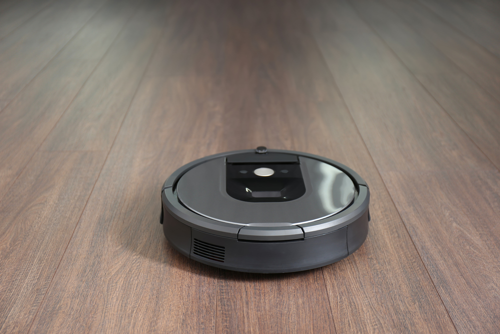 modern robotic vacuum cleaner on the wooden floor